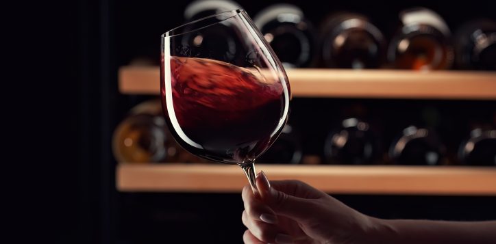 closeupfemalehandswirlingredwineinwineglass-2